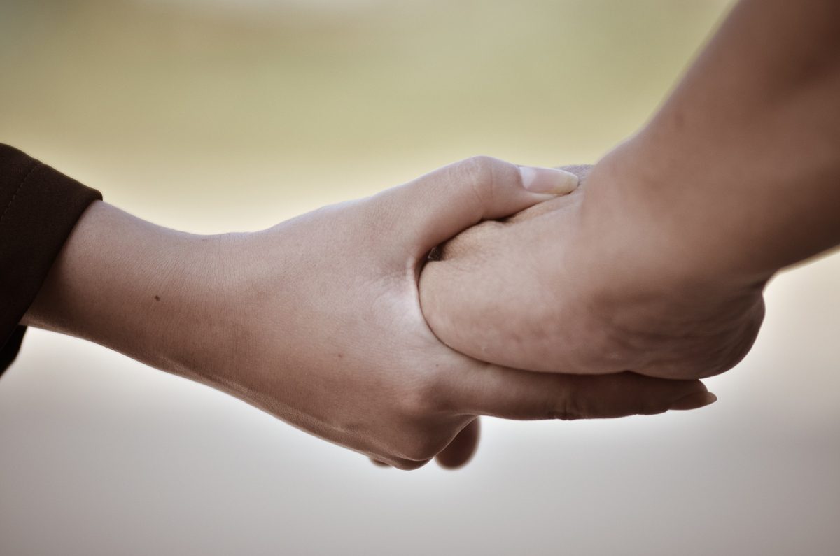 Two people holding hands and celebrating their freedom from benzodiazepine addiction in Utah