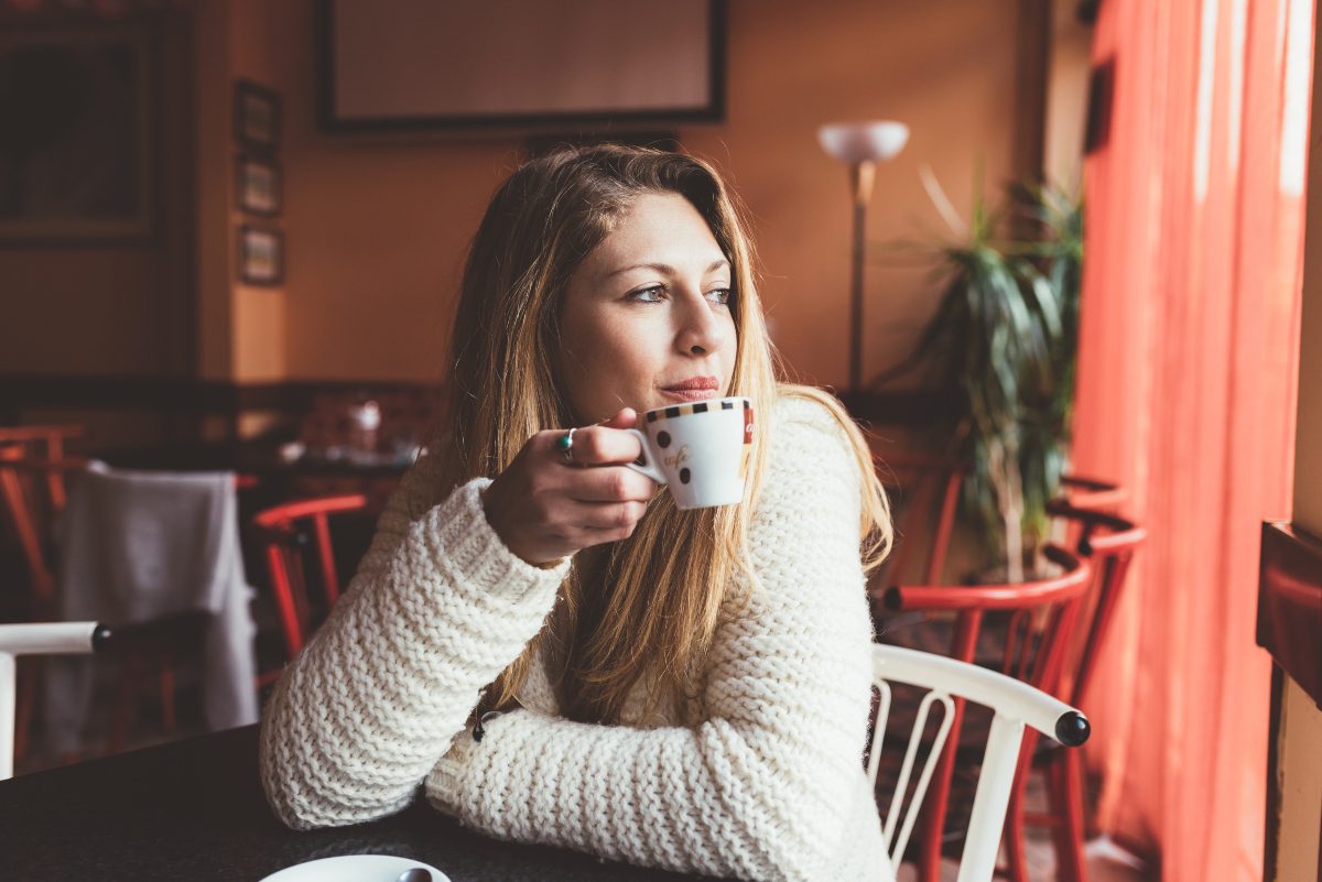 Woman choosing to drink coffee over going to a bar because she is in alcohol addiction treatment in Utah